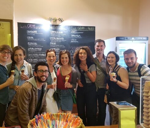 Group of tourists having artisanal gelato during our food tour in Bologna